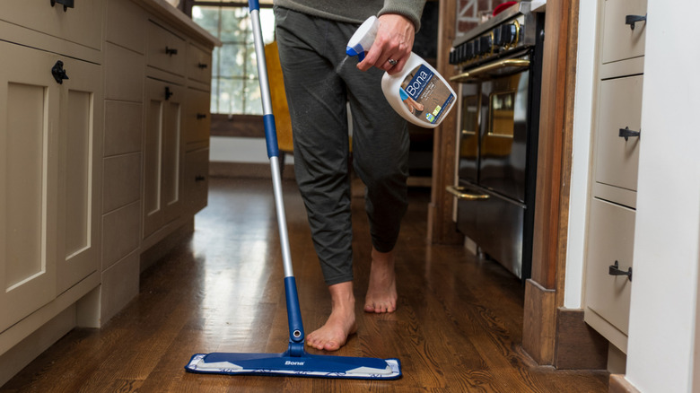 Person using Bona Hardwood Floor Cleaner on hardwood floor