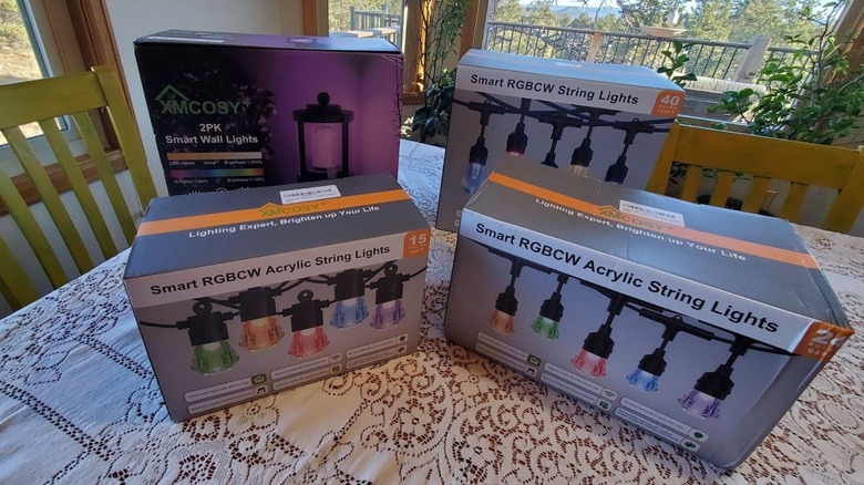 Three boxes of XMCOSY+ Smart RGBCW Acrylic String lights and a pack of Smart Wall Lights