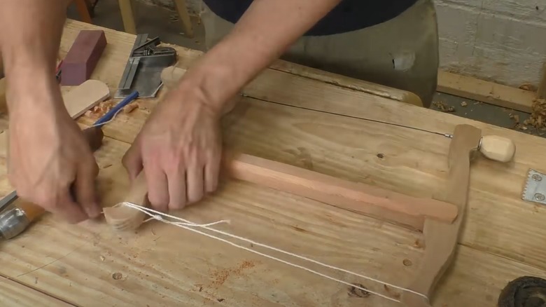 Man building a DIY turning saw