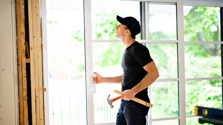 construction worker replacing patio door