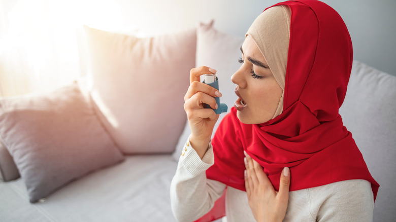 Woman using inhaler