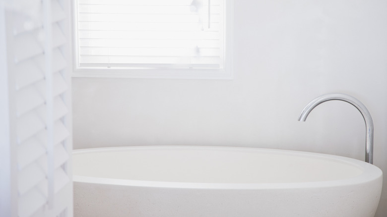 White bathtub in white bathroom