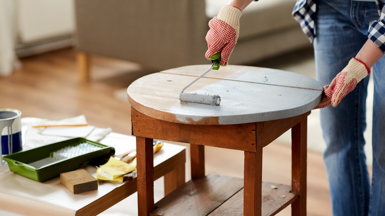 Person painting round table