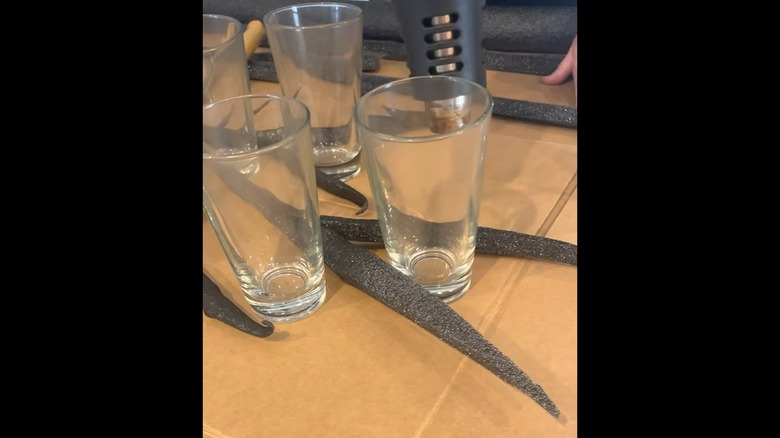 Black pool noodle pieces and glass cups