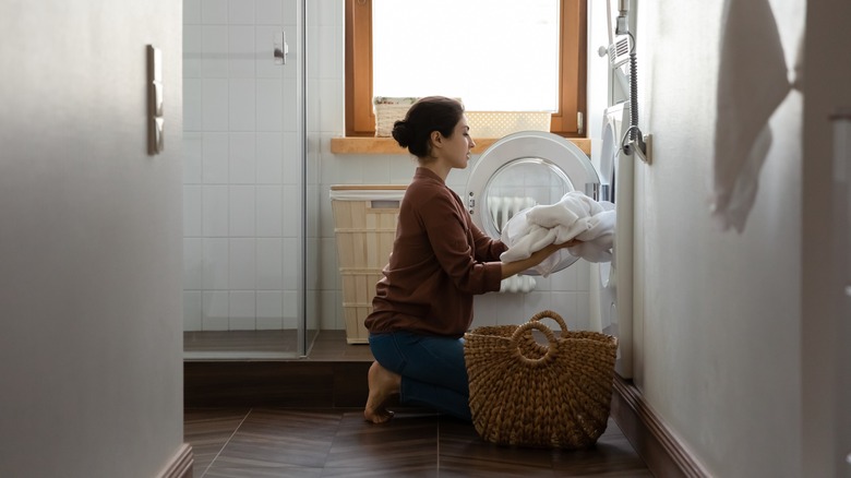 Woman loading whites into washer