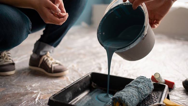 pouring paint into tray