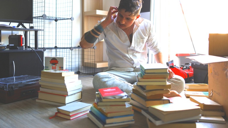 man cleaning and organizing books