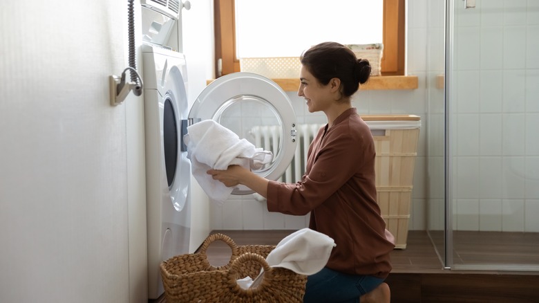 Person putting clothes in dryer