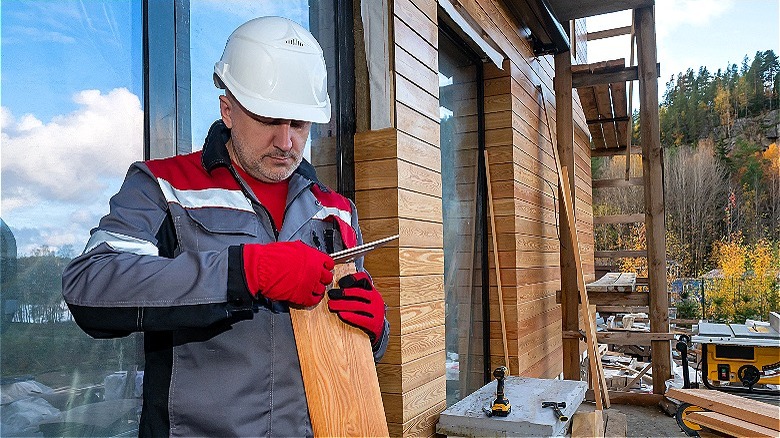 Person installing wood siding