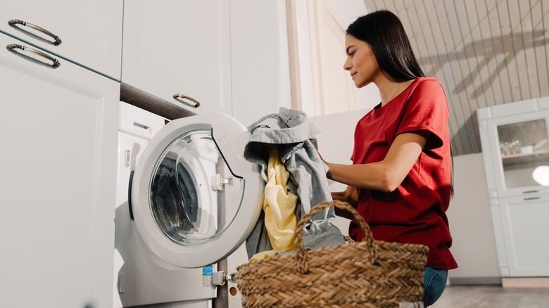 Person putting clothes into wash