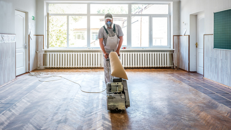 Sanding a hardwood floor with a drum sander