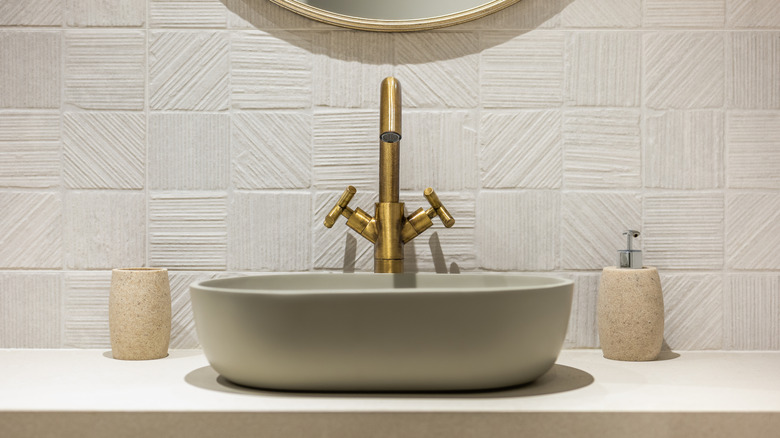A bathroom sink with brass fixtures