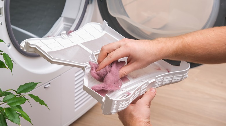 Person removing dryer lint