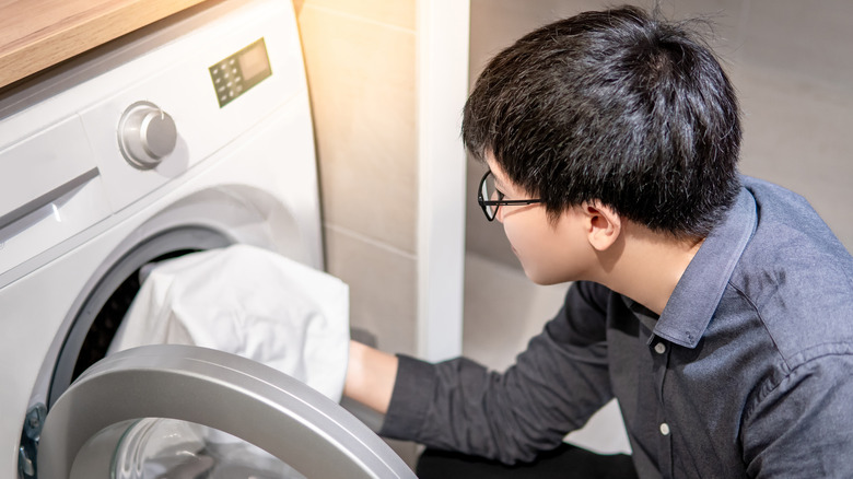 Man loading washing machine