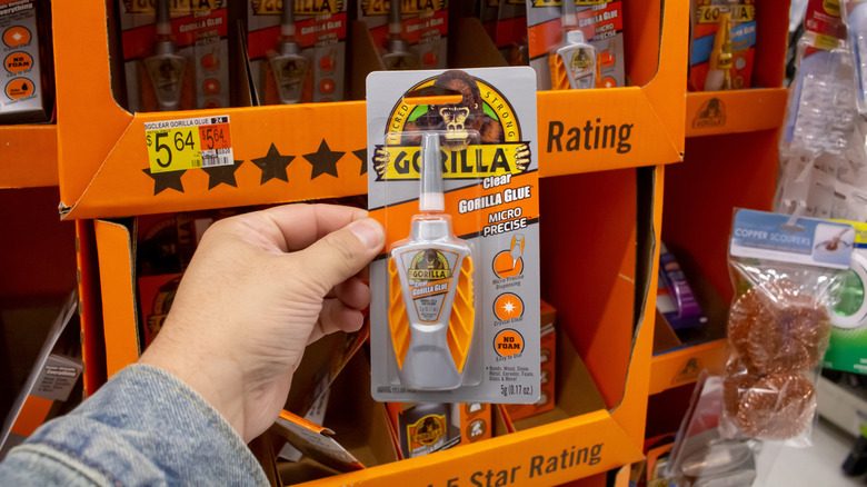 Person holding up Gorilla Glue in package.