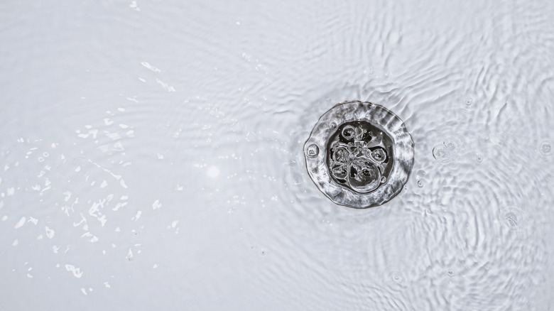 Water pooling around a slow bathtub drain