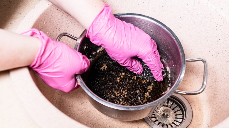 Scrubbing burned food in pan