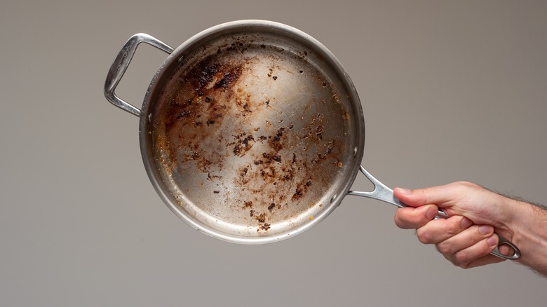 Burnt food in metal pan