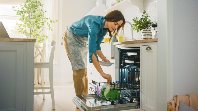 Person loading dishwasher