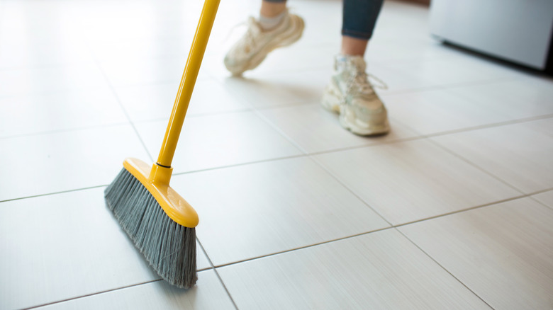 person sweeping with broom