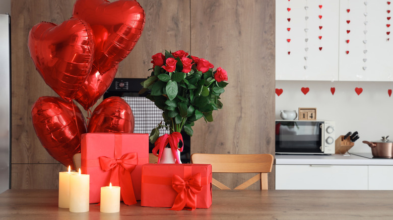 Valentine's Day gifts and candles on table