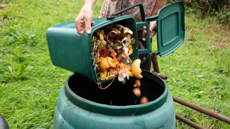 Woman emptying compost into bin